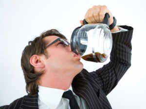 Businessman drinking coffee from coffee pot