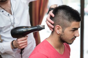 Stylist Drying Hair Of A Male Client